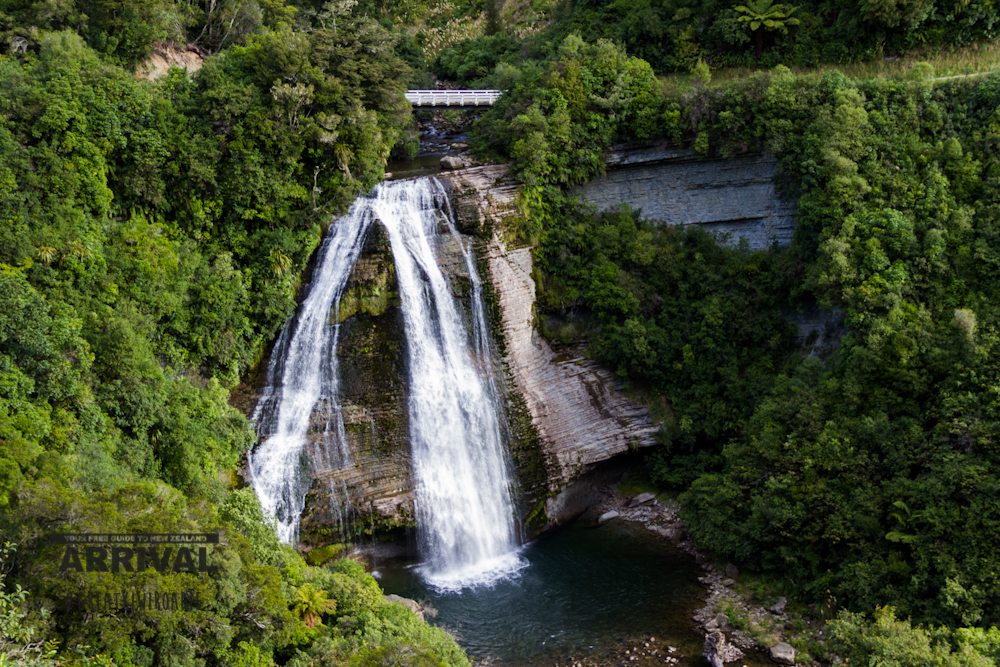 A one lane wooden bridge sits just above the 37meter Mokau Falls on State Highway 38.